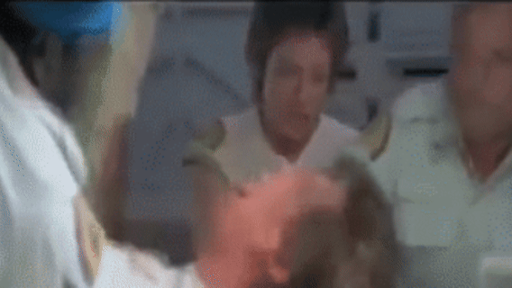 The crew reacts with absolute, visceral horror as an alien creature bursts out of Kane's chest. in Alien