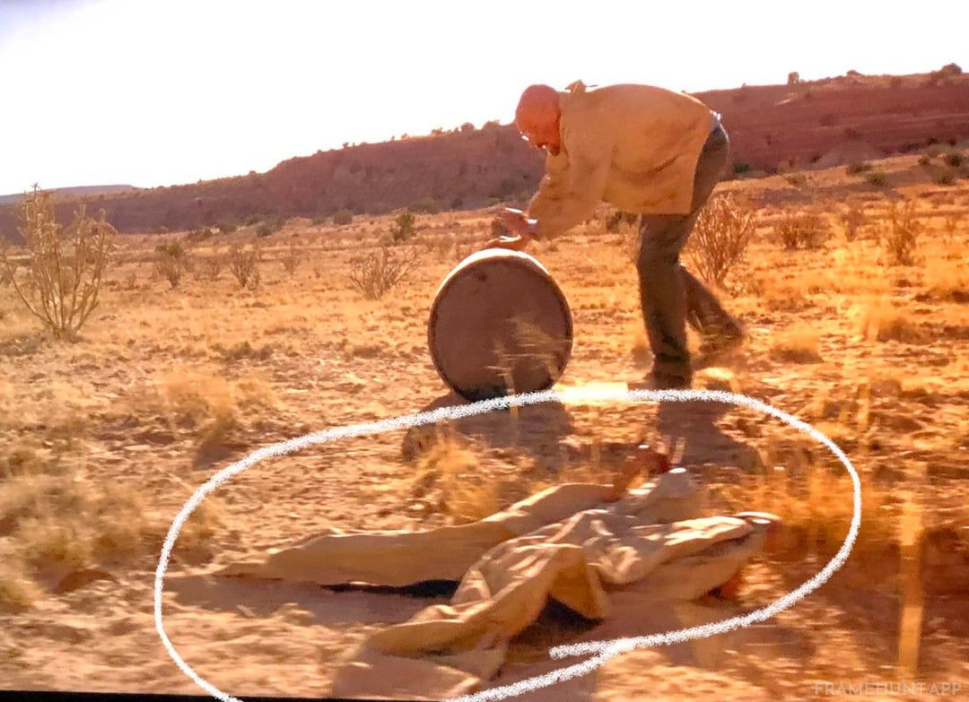 Walter White rolls his barrel of money through the desert, passing the exact coordinates where his trousers fell in the pilot episode. in Breaking Bad