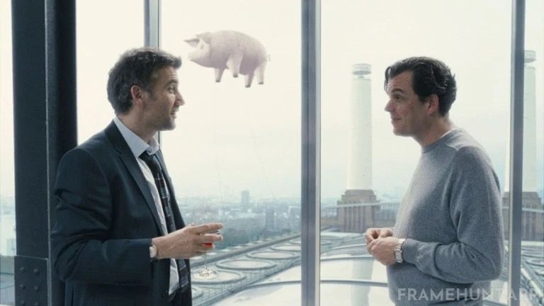 A massive inflatable pig can be seen floating between the chimneys of the Battersea Power Station in the background. in Children of Men
