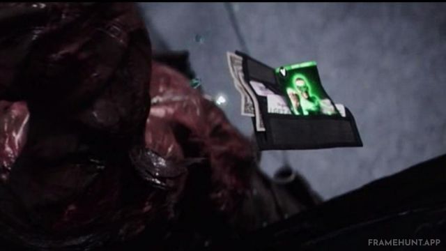 A trading card of Ryan Reynolds in his CGI Green Lantern suit floats out of a bad guy's wallet. in Deadpool