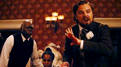Calvin Candie aggressively slams his hand on a glass on the dining table, heavily bleeding but continuing his intense monologue. in Django Unchained
