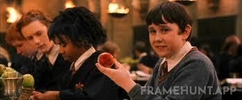 Neville Longbottom's Remembrall turns red because he is the only student who forgot to put on his black school robe. in Harry Potter and the Philosopher's Stone