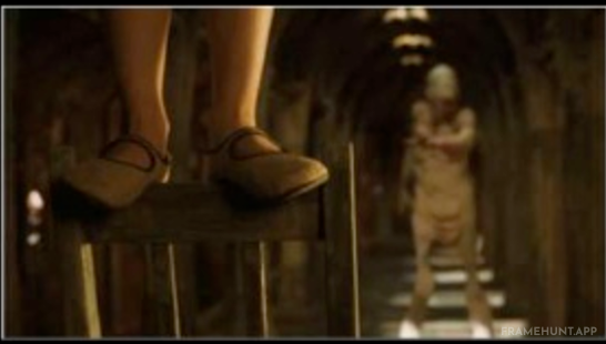 A massive mountain of discarded leather shoes is visible in the corner of the Pale Man's chamber. in Pan's Labyrinth