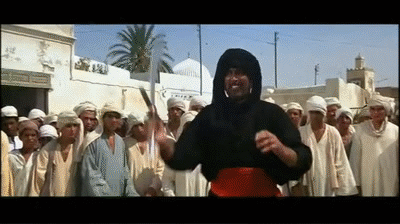 Indiana Jones wearily pulls out his revolver and shoots a flamboyant, sword-wielding assassin in a bustling Cairo marketplace. in Raiders of the Lost Ark