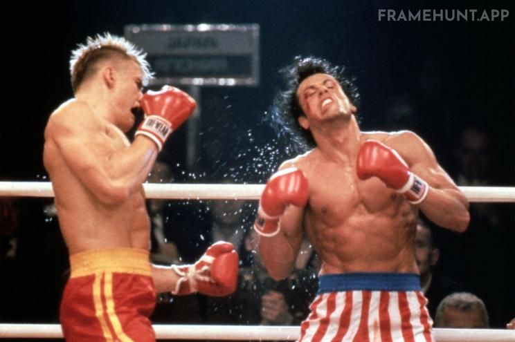 Rocky Balboa takes a devastating, full-force punch to the chest from Ivan Drago during their brutal boxing match. in Rocky IV