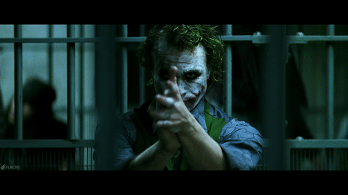 The Joker sits alone in his holding cell, mockingly clapping as Jim Gordon is promoted to Commissioner. in The Dark Knight