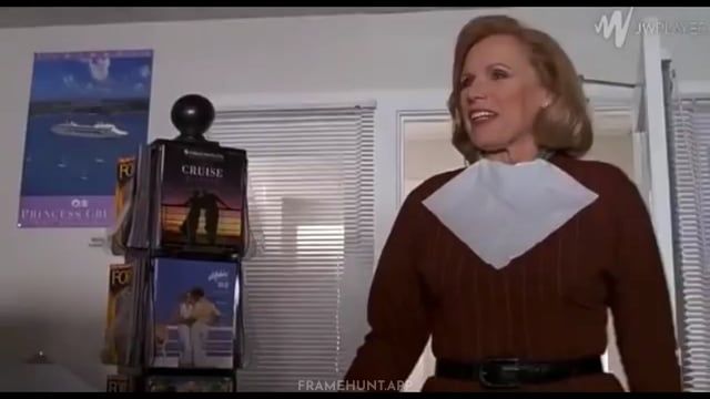 The travel agent Truman visits is still wearing her makeup bib and hasn't finished pinning her hair. in The Truman Show
