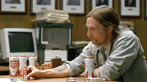Rust Cohle unknowingly sculpts a spiral and a crown out of Lone Star beer cans during the interview. in True Detective