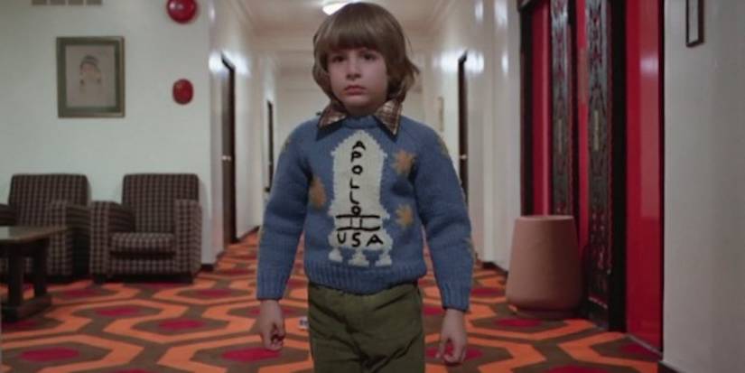 Danny is wearing an Apollo 11 sweater while walking toward Room 237. in The Shining