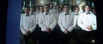 Tyler Durden appears standing in the front row of a hotel welcome video playing in the background. in Fight Club