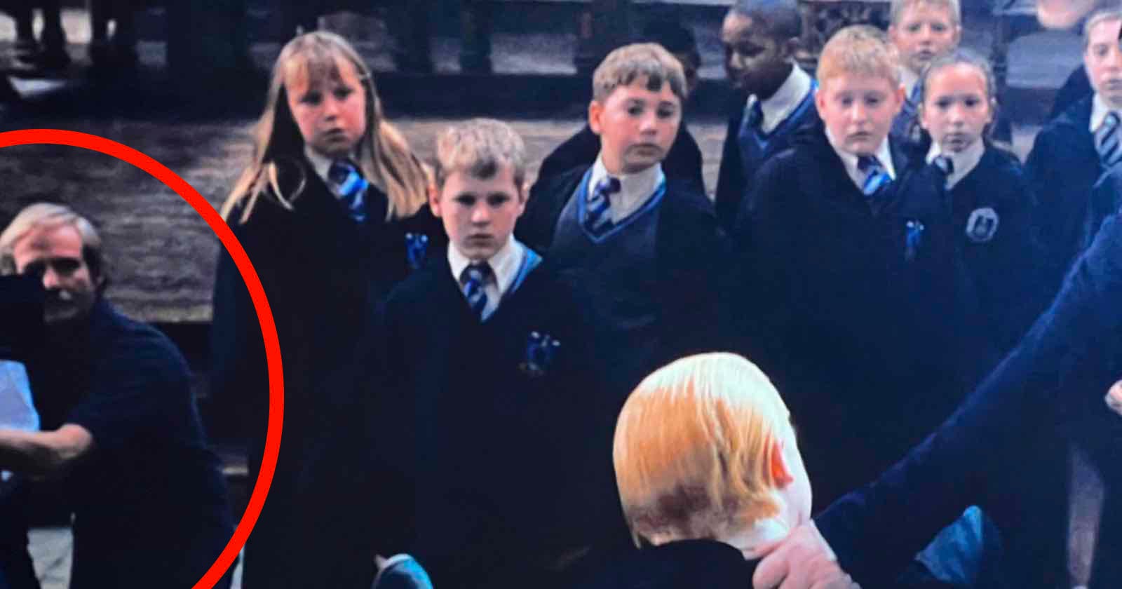 A cameraman kneeling with a large cinema camera is visible among the Hogwarts students. in Harry Potter and the Chamber of Secrets