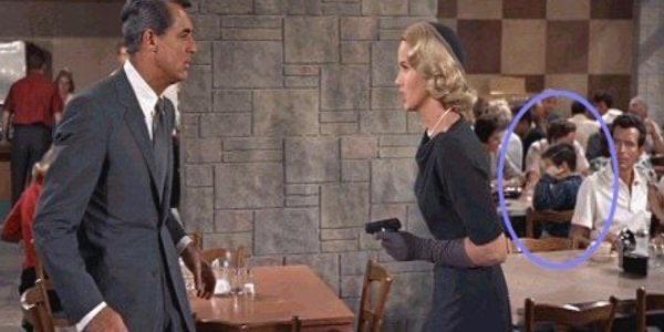 A young extra in the background covers his ears seconds before a loud gunshot happens. in North by Northwest