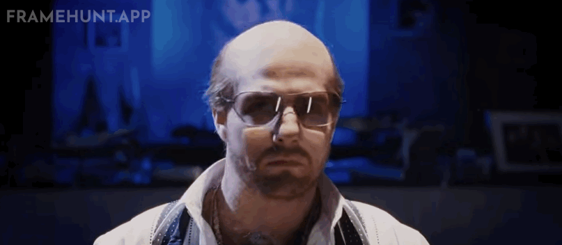 Tom Cruise is completely unrecognizable in a fat suit, bald cap, and prosthetic hands, playing ruthless studio executive Les Grossman. in Tropic Thunder