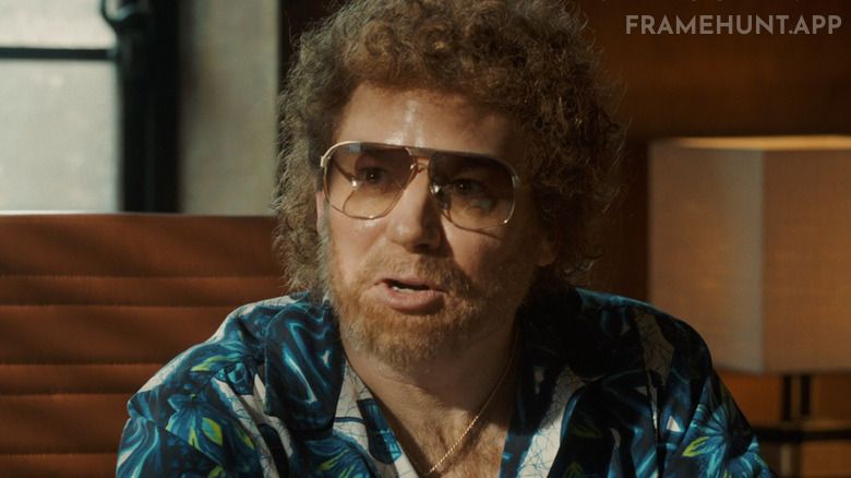 Mike Myers, heavily disguised, plays the record executive who claims nobody will ever headbang to "Bohemian Rhapsody." in Bohemian Rhapsody