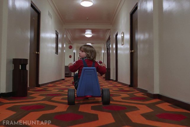 The sound of Danny's tricycle abruptly shifting from loud plastic to total silence creates deep psychological tension. in The Shining