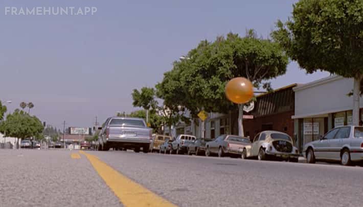 When the criminals are walking down the street, an orange balloon floats behind the undercover cop. in Reservoir Dogs